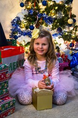 Happy girl opening her Christmas gifts