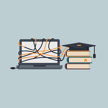 Laptop tangled with cables next to stacked books and a graduation cap.