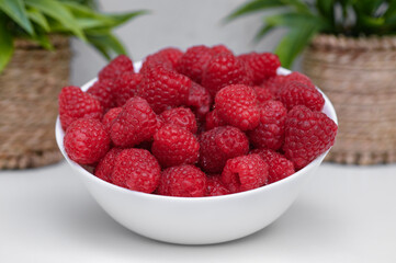 A bowl filled with fresh, juicy red raspberries