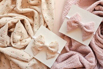 Delicate floral baby bows and soft muslin fabric in pastel shades