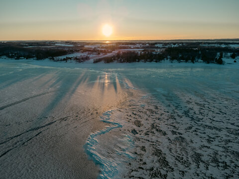 Winter sunset over a frozen lake landscape in Michigan