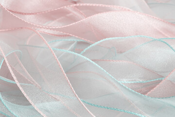 A background of curved organza ribbons in pastel colors