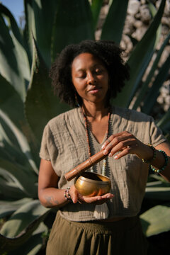Serene portrait Female Sound Healer in Botanical Garden at Sunset