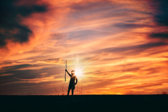 Boy Standing on Hill Silhouette