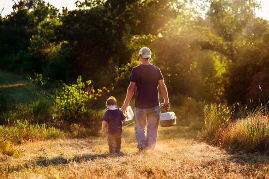 Father and Son Walking to go Fishing