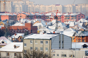 Snowy rooftops adorn a bustling winter cityscape