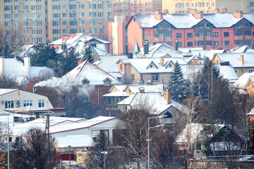 Snowy rooftops and cozy homes in a winter wonderland landscape