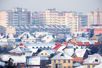 Snow blankets rooftops in a tranquil winter cityscape scene