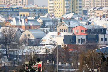 Quiet winter morning in a cozy neighborhood with snow-covered roofs
