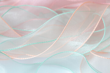 A background of curved organza ribbons in pastel colors