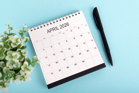 April 2026 desk calendar on blue background