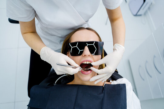 Dentist performs dental checkup examining teeth and maintaining oral health.