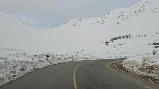Snow-covered mountain road winding through rugged snowy peaks and a remote winter landscape under a cold, overcast sky.
📍Hawraman Takht, Kurdistan 