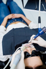 Air Flow dental hygiene procedure for removing stains and plaque on teeth.