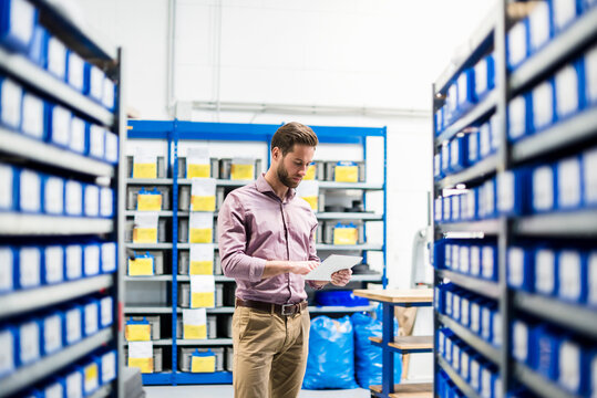 Businessman using tablet in storage