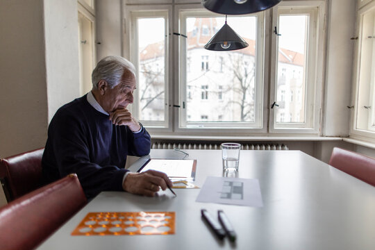 Senior man using tablet with architectural plan