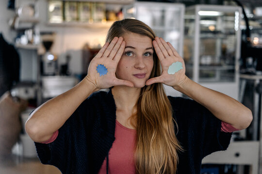 Portrait of young woman with thought bubble stcikers on her hand