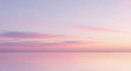 Fototapeta premium Dreamy pastel sunset over the tranquil ocean, featuring soft pink, purple, and blue hues creating a serene horizon.