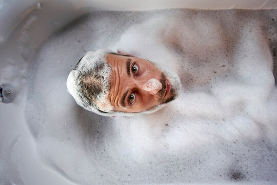 Man having a relaxing bath in the bathtub
