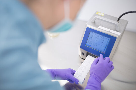 Scientist using device in laboratory for drug production