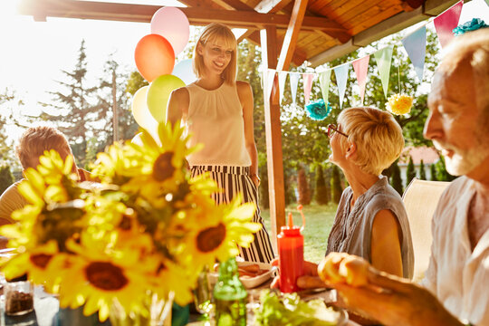 Happy couple with parents having a garden party