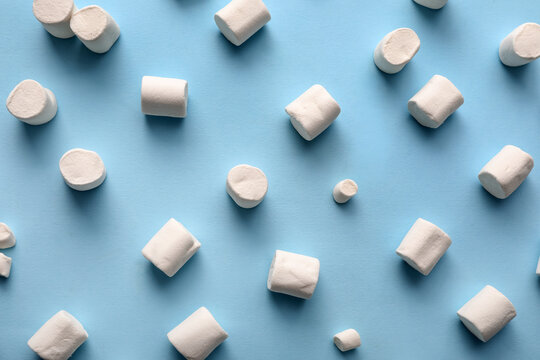 Sweet marshmallows on blue background