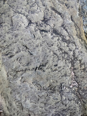 Fototapeta premium Dark rough rock texture with natural stone patterns and gritty surface details for backgrounds 