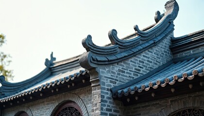 Fototapeta premium Ancient Chinese building roof detailed view. Traditional gray brick construction with curved tiles and decorative elements. Classic Asian architecture exterior close-up.