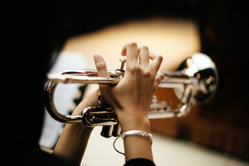 Close-up Trumpet Player Practicing in a Music Rehearsal Room © maha