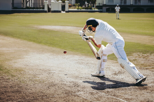 Cricket batsman playing a cover drive shot on a sunny day