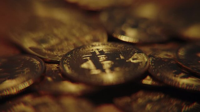 Golden bitcoin coins falling through the air against a dark background, symbolizing cryptocurrency market crash, financial volatility and investment risk