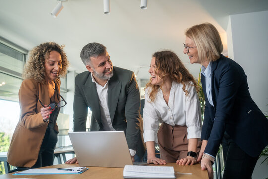 Diverse business team having meeting in office with positive collaborative atmosphere