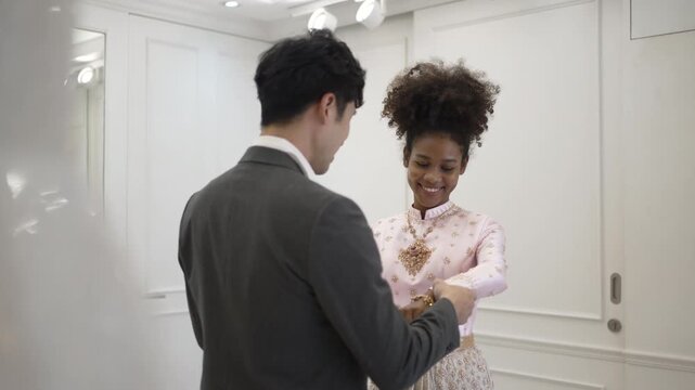 The couple is choosing dress for wedding event at wedding studio. Lifestyle, wedding event.