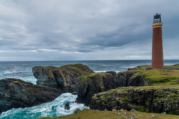The 37 metre red brick tower of the Butt of Lewis Lighthouse over high sea cliffs at the most northerly point of the Isle of Lewis, Outer Hebrides, Scotland, UK © Karl Allen Lugmayer