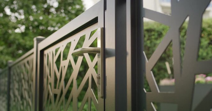 Modern metal garden gate with laser cut geometric pattern