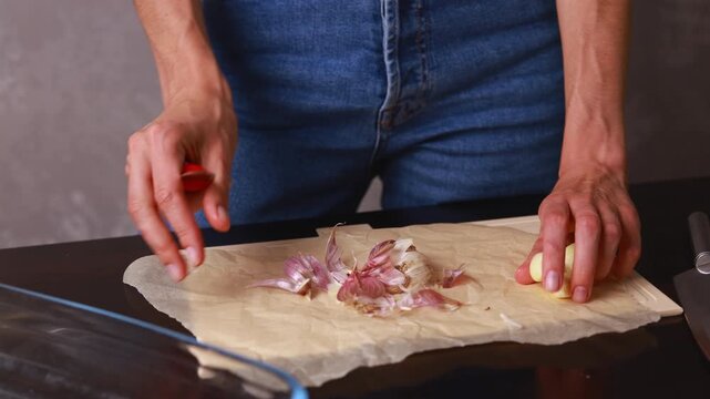 Chopping garlic in a kitchen with a cutting board and a knife on a Friday afternoon