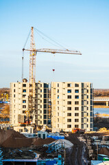 Construction site - view from height, a tower crane at the construction site, construction of a panel house