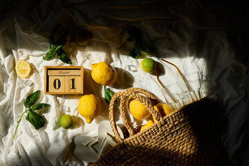 Lemons and lime are arranged artfully with fresh greens, ice cubes, and a woven basket, capturing a...