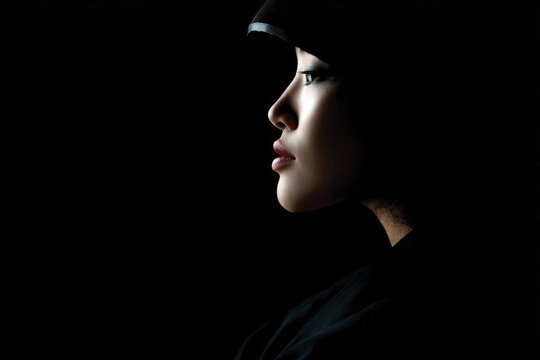 A graceful profile illuminated by soft ambient light creates a striking visual, highlighting the subject's elegance and inviting contemplation of beauty and artistic expression.