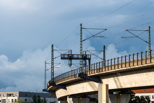 Concrete railway viaduct bridge with catenary above tracks showing urban infrastructure engineering and transport network in Berlin Germany