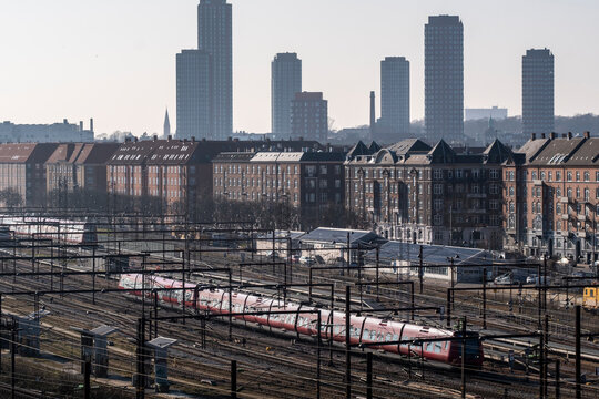 Railway tracks with Copenhagen Denmark skyline and industrial cityscape showing urban transport infrastructure and connected mobility network