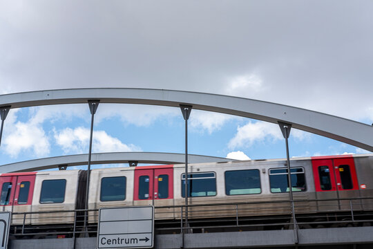 Metro train passing station platform with rail commuter travel and urban transport architecture details in Hamburg Germany public transit scene