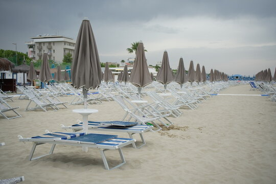 Beach with Sunbeds and Umbrellas during cloudy day in Giulianova, Italy. 