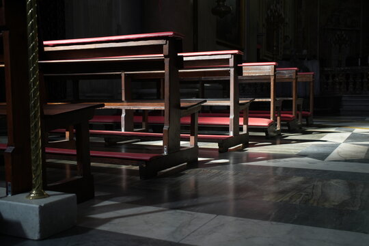 Benches inside a church, wooden seating, interior, religious space, quiet atmosphere, worship, architecture, sacred, peaceful environment.