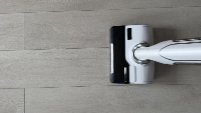 A modern cordless vacuum cleaner for wet and dry cleaning when cleaning laminate floors. High-tech smart machine for deep cleaning. Home appliances for easy housekeeping.