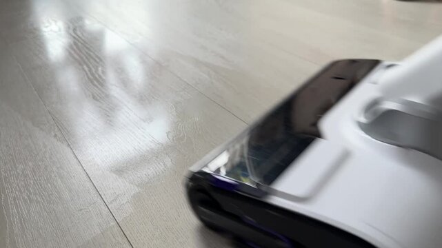 Minimalist home interior with high-tech cleaning appliance. Aesthetic floor care in a bright modern apartment. Concept of organized living space, decluttering and sleek product design.