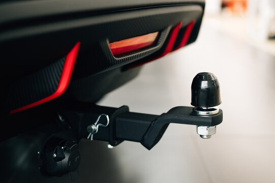 Car tow hitch with protective rubber cap and electrical connector mounted on rear bumper