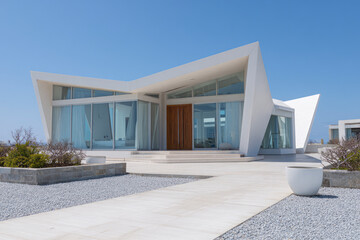 Modern house with angular design and large windows.