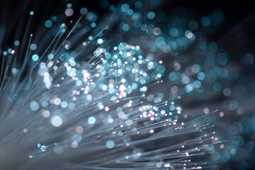 Abstract close-up of glowing blue and white fibers.