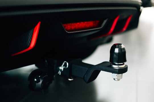 Car tow hitch with protective rubber cap and electrical connector mounted on rear bumper